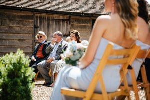 Father of the Groom wiping away tears during wedding ceremony