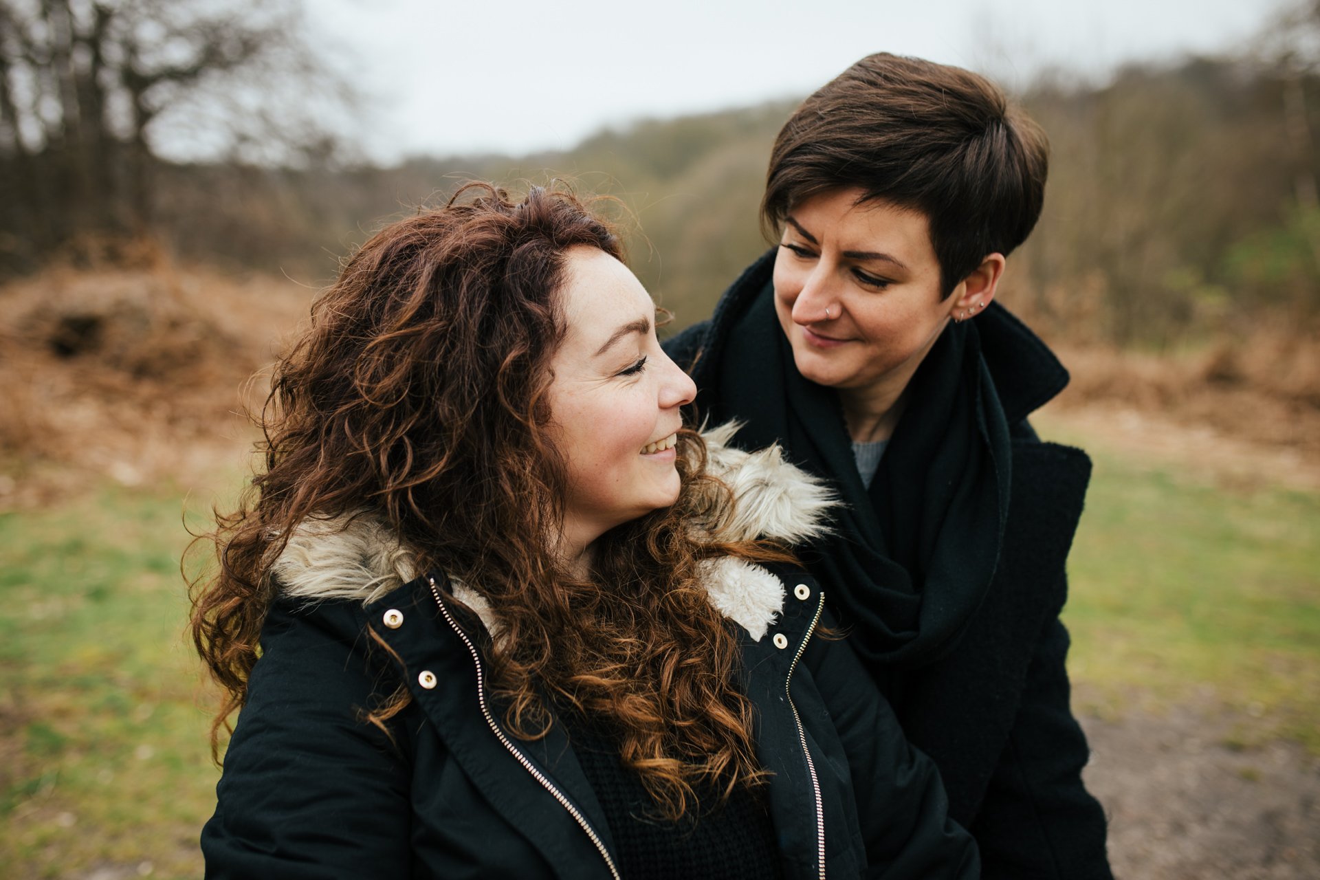 Two gorgeous ladies smiling during their engagement shoot at Shorne Woods Country Park in Kent