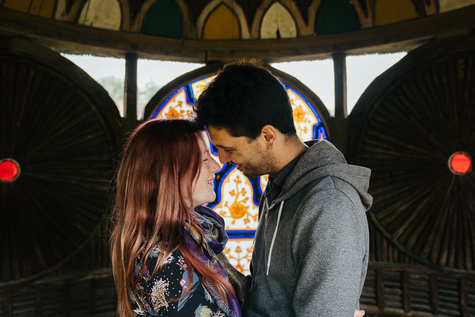 Happy couple about to kiss under Indian Kiosk at Swiss Gardens during their engagement shoot