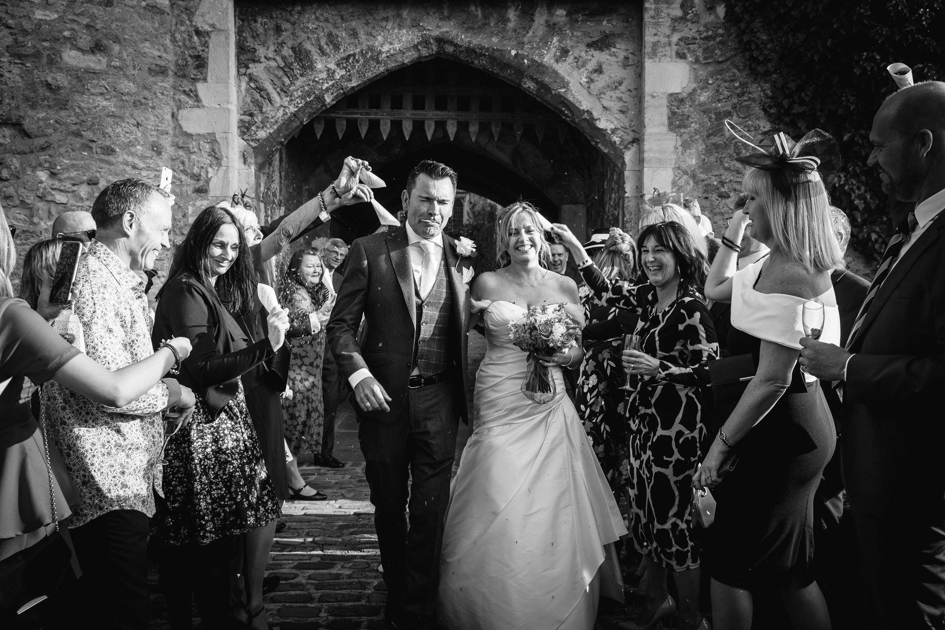 Bride and Groom showered with confetti as they exit their Kent Castle Wedding at Allington