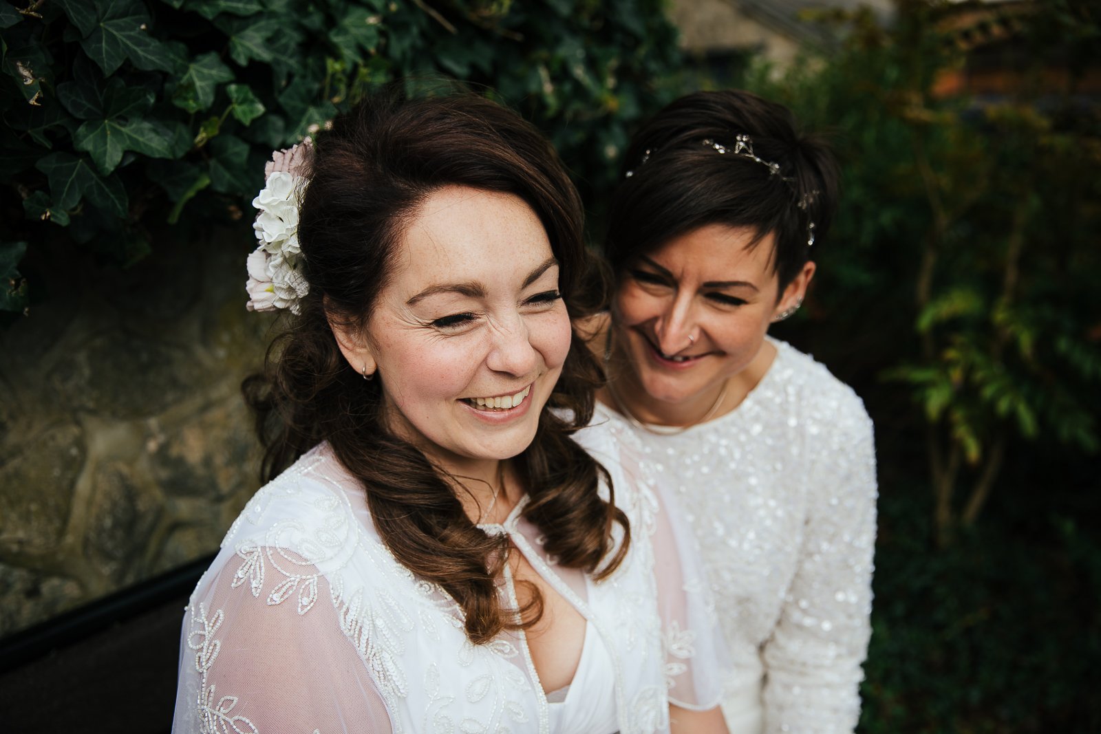 Brides laughing during their wedding portraits