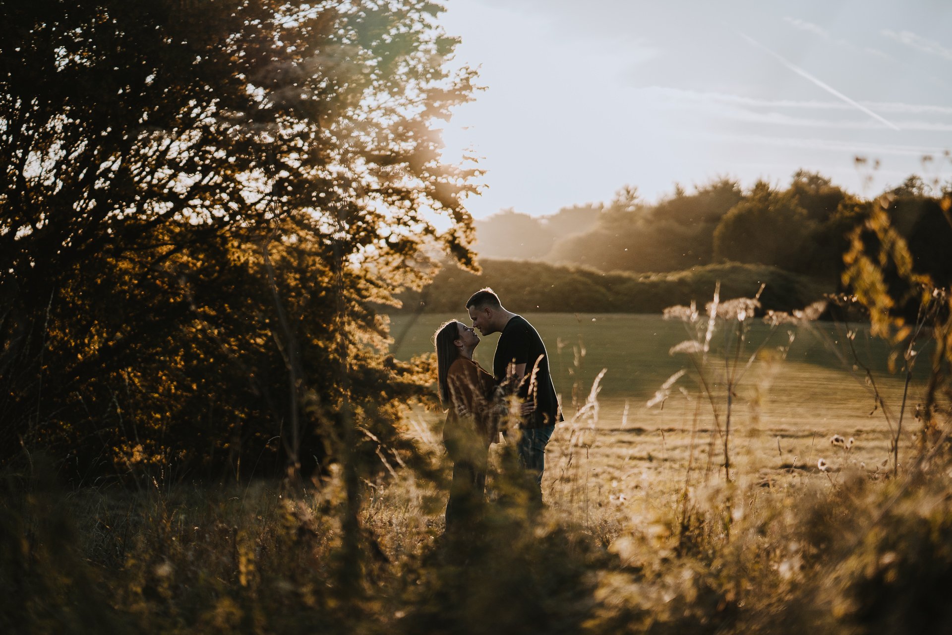 Engaged couple looking at each other during their golden hour couple shoot at Lullingstone Country Park, Kent