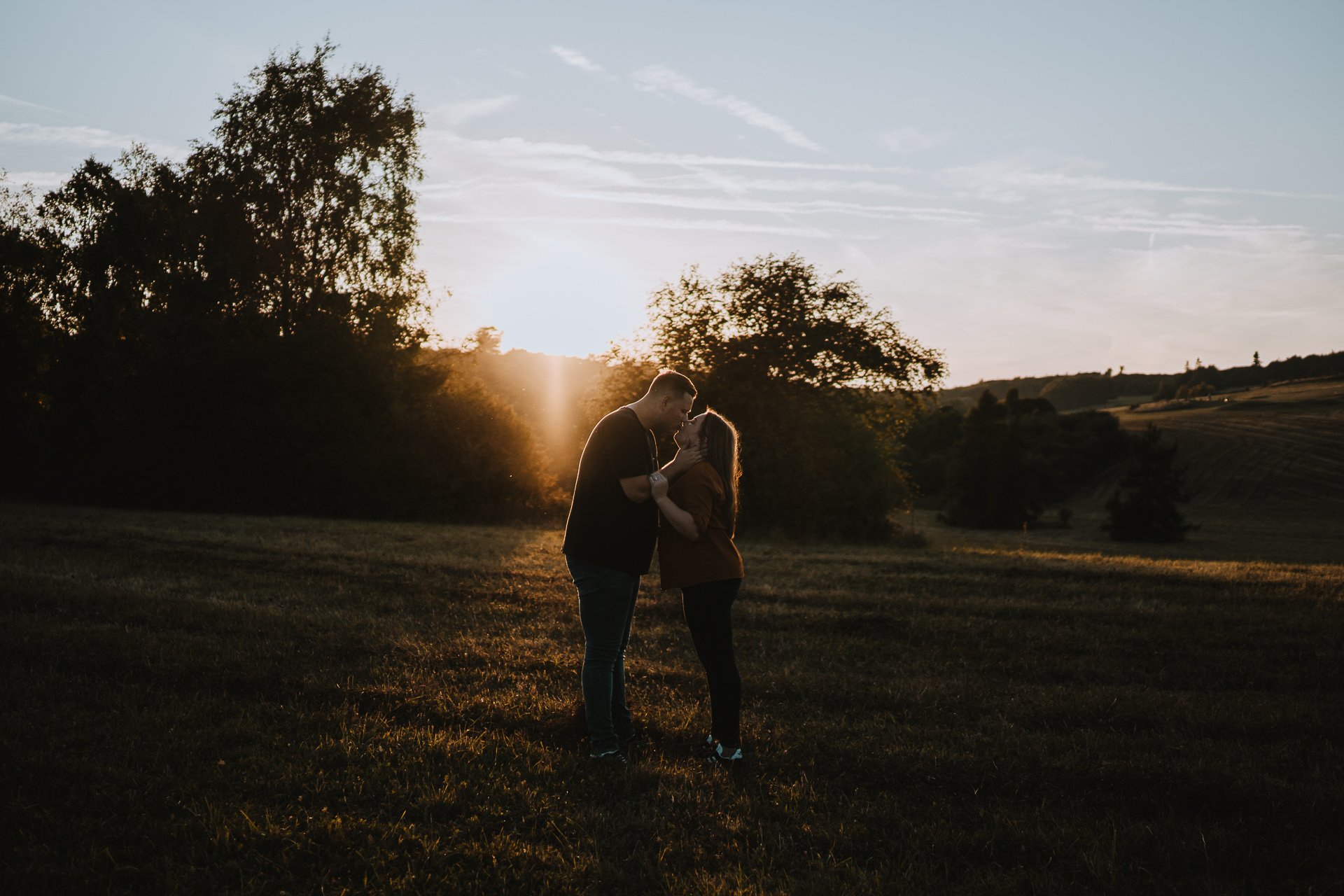 Engaged couple about to kiss during their golden hour couple shoot at Lullingstone Country Park, Kent