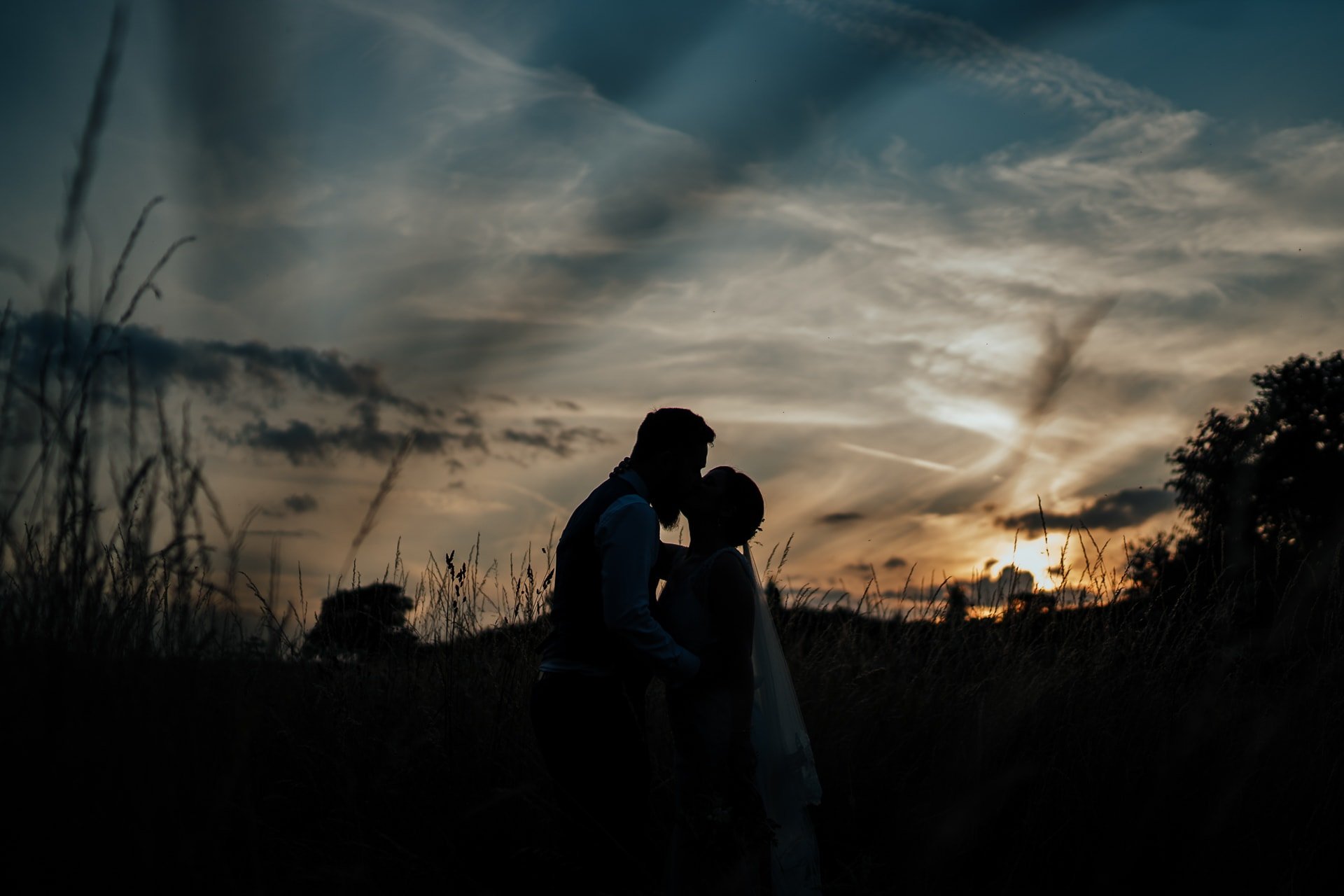 Bride and Groom kissing at sunset