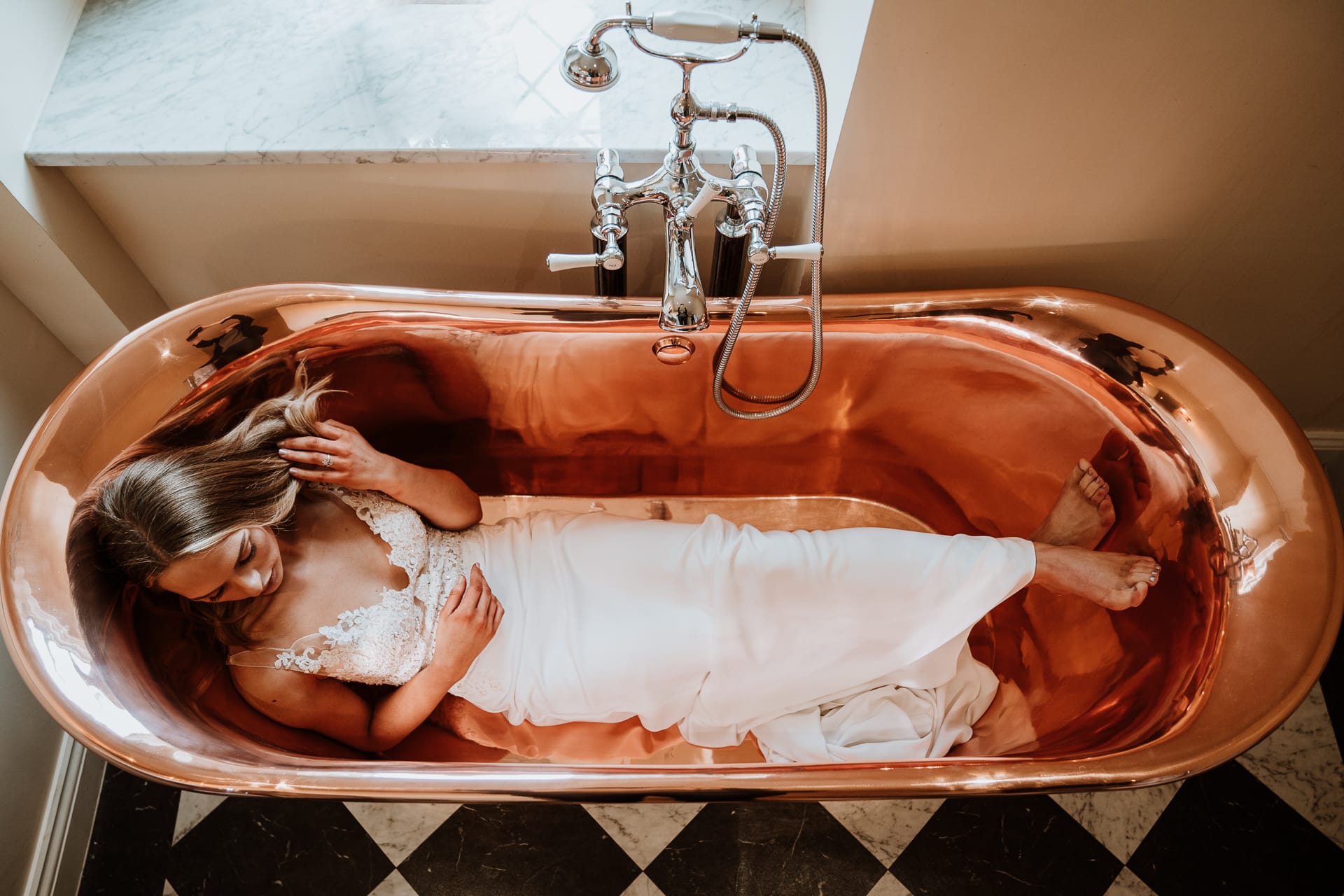 Bride in copper bath at Eastwell Manor