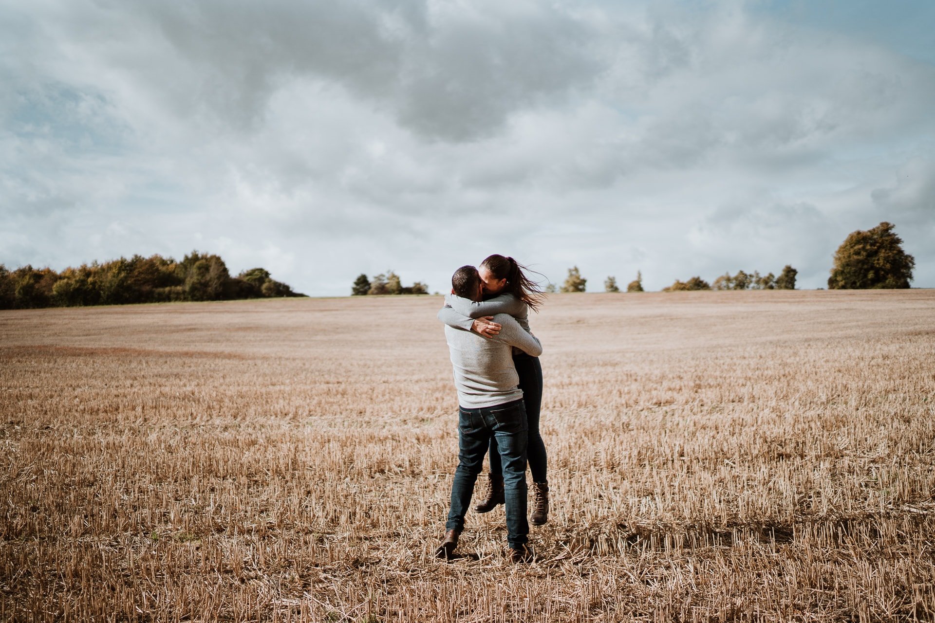 Couple hugging in a field