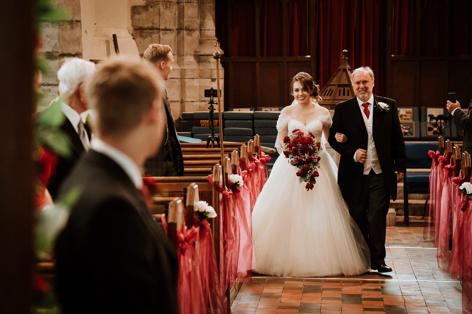 Groom looking at his Bride for the first time as she is walked down the aisle by her father