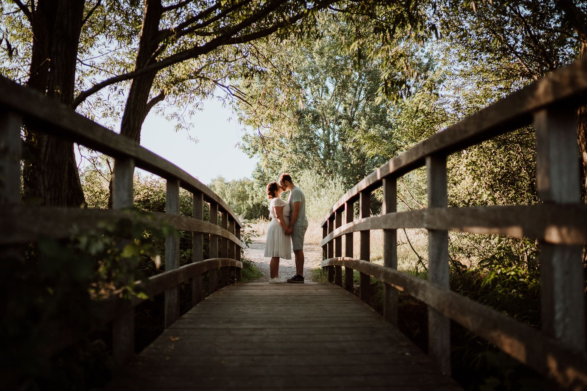 Couple kissing on bridge