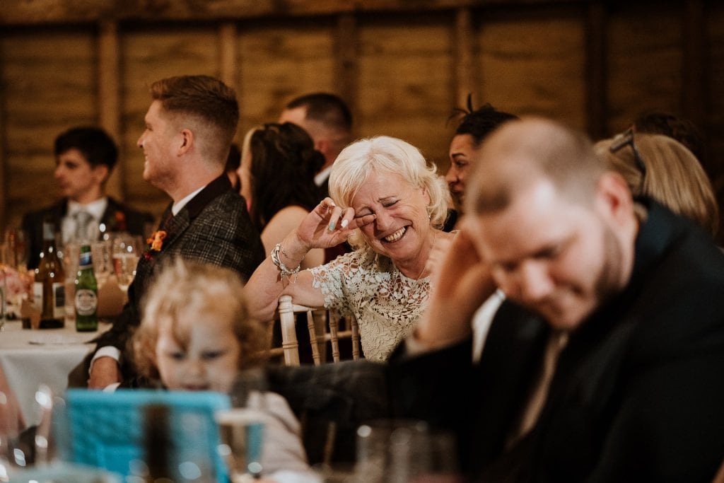 Mother of the Bride crying with laughter during wedding speeches
