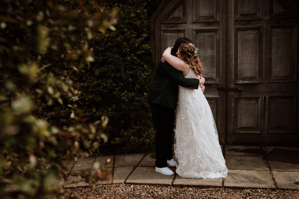 Two Brides embracing after a first look at Winters Barns