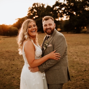 Bride and Groom laughing together at sunset