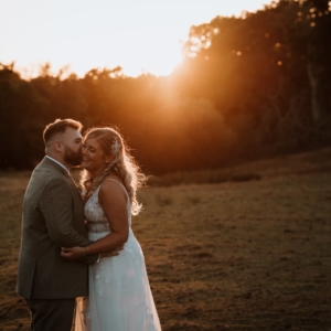 Relaxed Bride and groom kissing at sunset