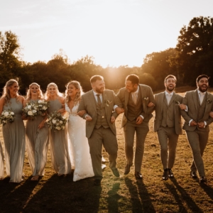 Wedding party group laughing in sunset at Kent Wedding venue