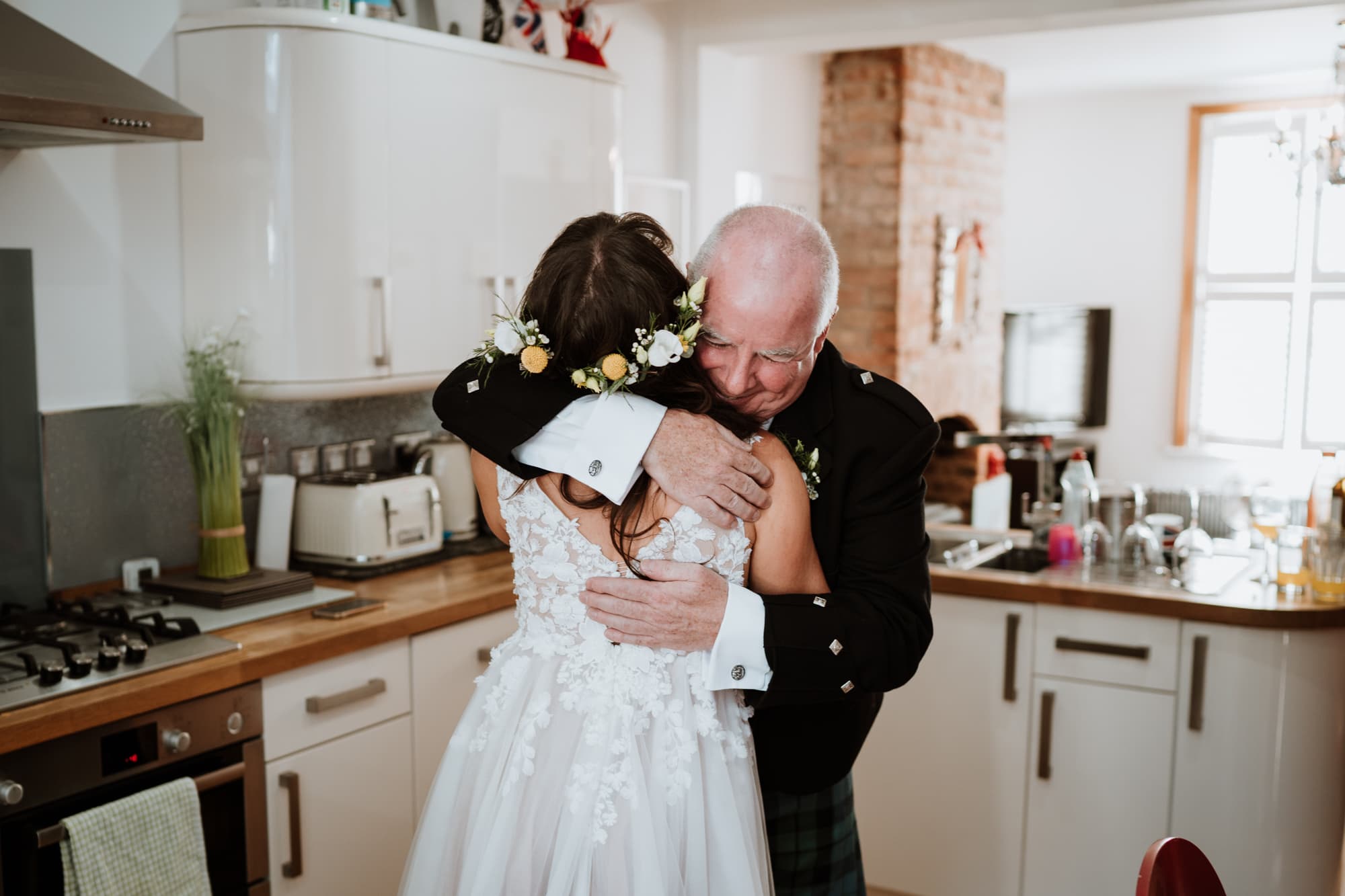 Bride and her father having a cuddle after seeing each other for the first time before her wedding