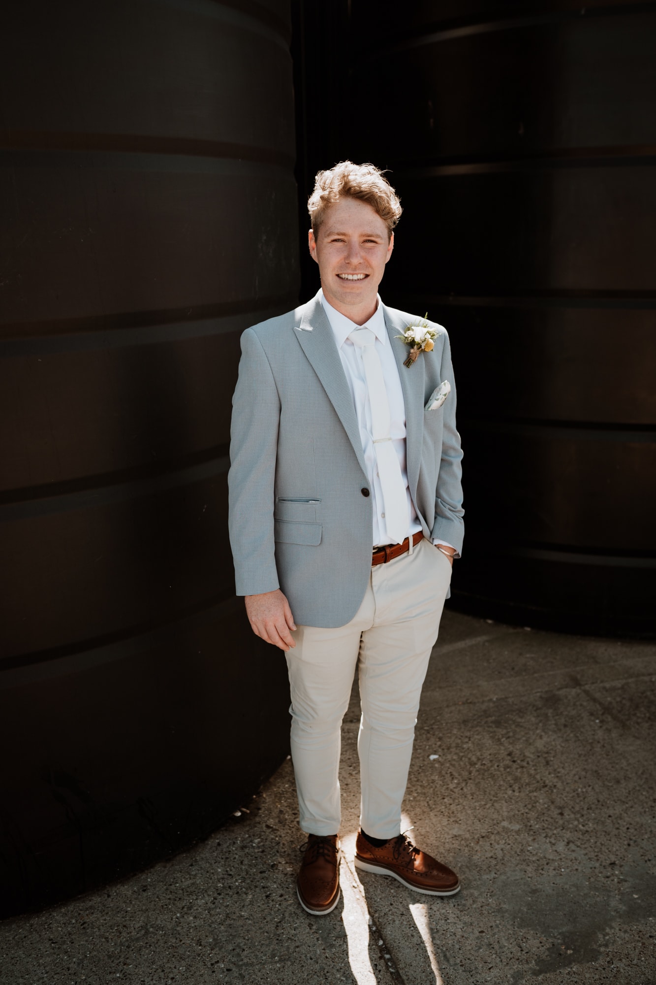 Blonde Groom in chinos and light blue blazer before his wedding ceremony at East Quay