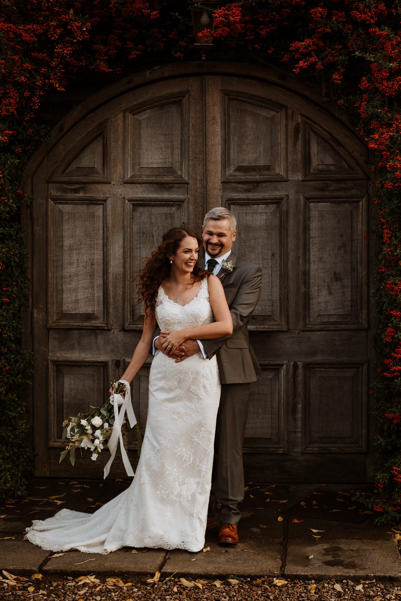 Bride and groom infront of the wooden doors at Winters Barns Wedding venue in Kent