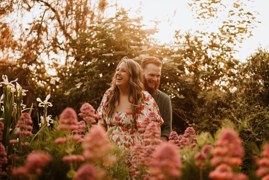 An engagement photoshoot idea in the fields during golden hour