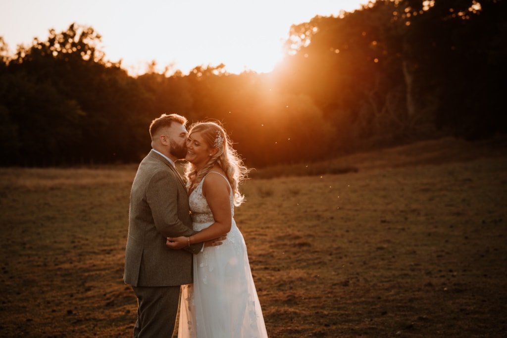 Relaxed couple at sunset on their wedding day at Oak Barn