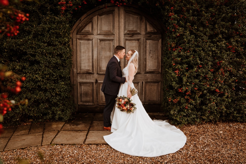 The couple standing outside of Winters Barns in Canterbury which is a wedding venue in Kent 