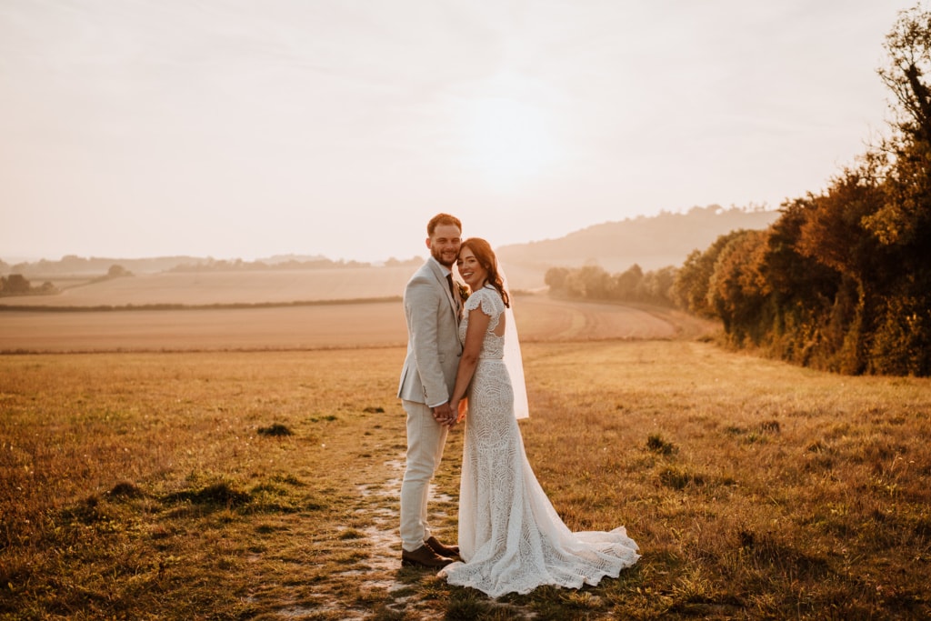The couple standing outside of Buttery and Glasshouse in Wrotham which is a wedding venue in Kent during their sunset portraits