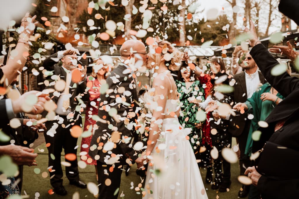 The couple during their confetti moment at Buttery and Glasshouse in Wrotham which is a wedding venue in Kent
