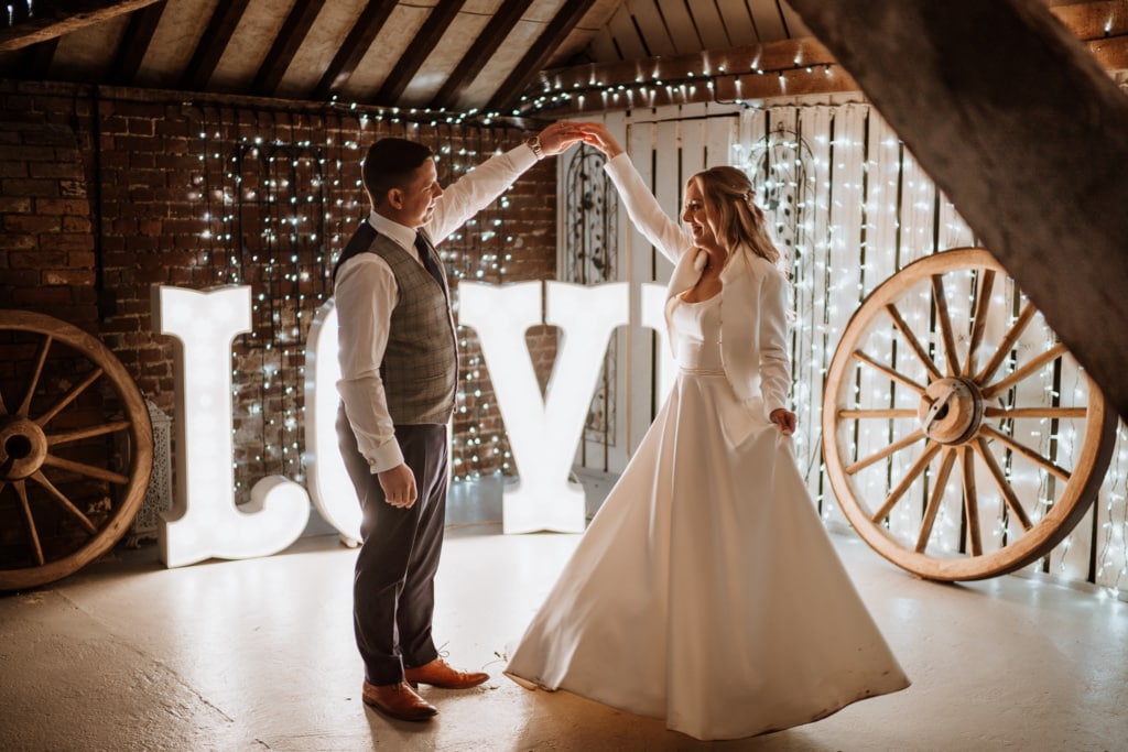 The couple inside of Winters Barns in Canterbury which is a wedding venue in Kent during their first dance