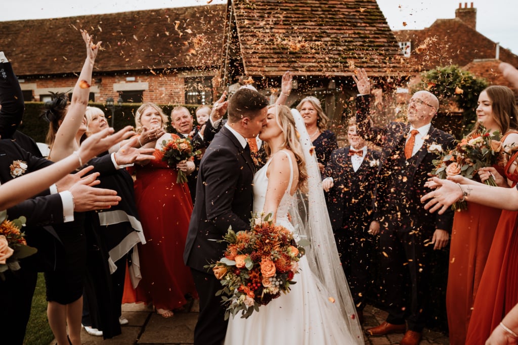 Couples kissing during confetti moment at a Kent wedding