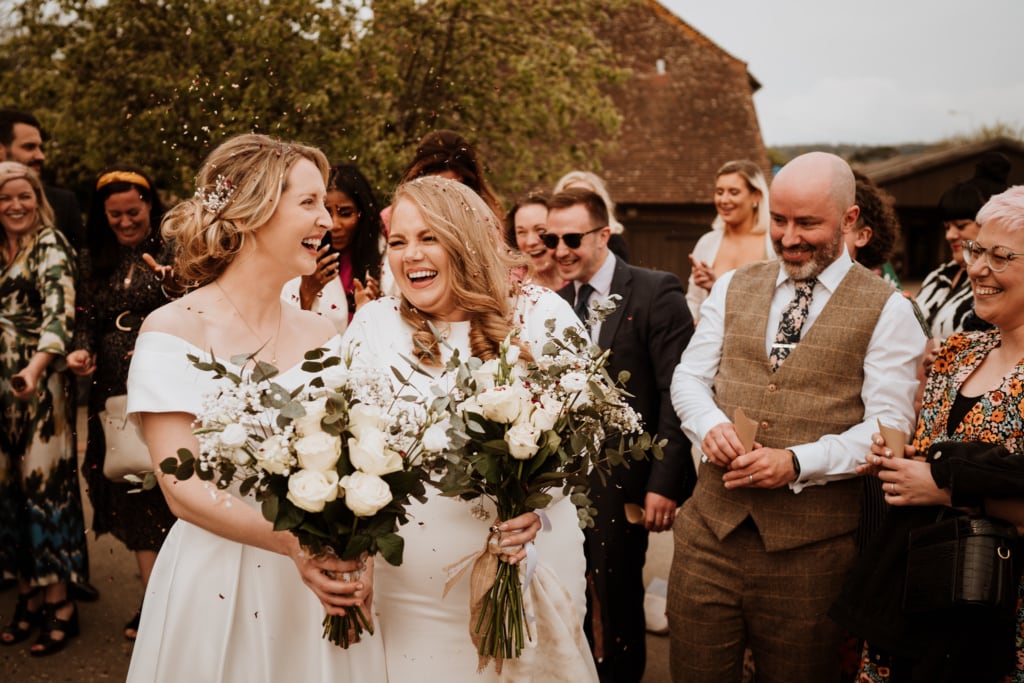 Couple during their confetti moment captured by a wedding photographer in Kent