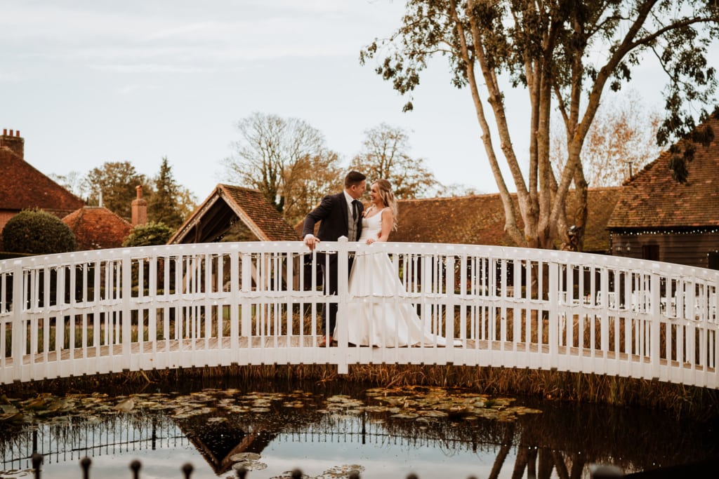 The couple standing on the bridge at Winters Barn in Kent